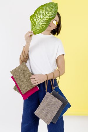 Kwooksta soft and herringbone jute clutch pouch range with model using eco leather wrist strap