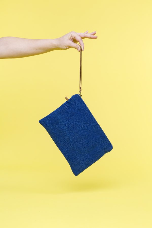 Kwooksta soft jute clutch pouch in blue hanging from eco leather wrist strap