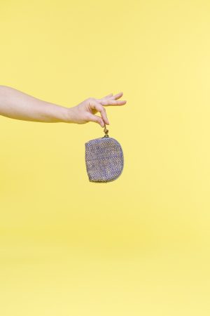 Kwooksta herringbone jute coin purse hanging from hand
