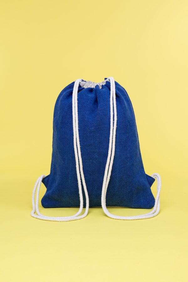 Kwooksta soft jute drawstring bag back view in blue and natural with white cotton straps