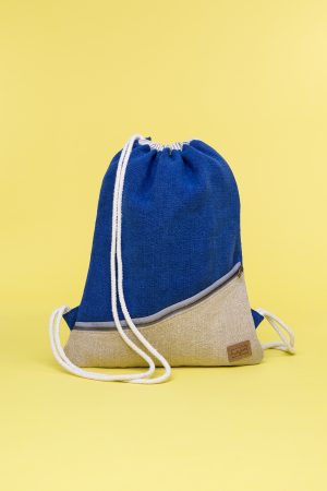 Kwooksta soft jute drawstring bag front view in blue and natural with diagonal front zipper and white cotton straps