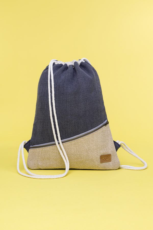 Kwooksta soft jute drawstring bag front view in grey and natural with diagonal front zipper and white cotton straps