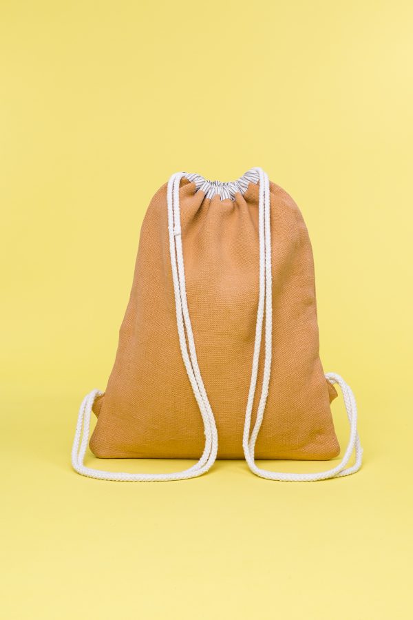 Kwooksta soft jute drawstring bag back view in orange and natural with white cotton straps