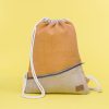 Kwooksta soft jute drawstring bag front view in orange and natural with diagonal front zipper and white cotton straps