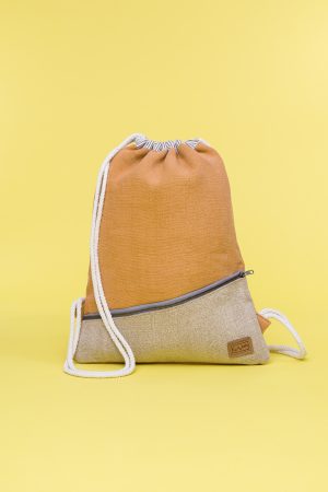 Kwooksta soft jute drawstring bag front view in orange and natural with diagonal front zipper and white cotton straps