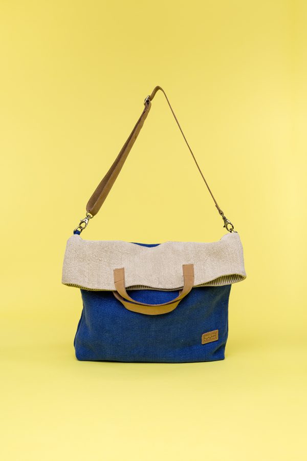 Kwooksta soft jute foldable tote bag folded view in blue and natural with eco leather handles and shoulder strap