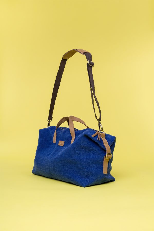 Kwooksta soft jute little weekender bag side view in blue with eco leather handles and adjustable cotton shoulder strap